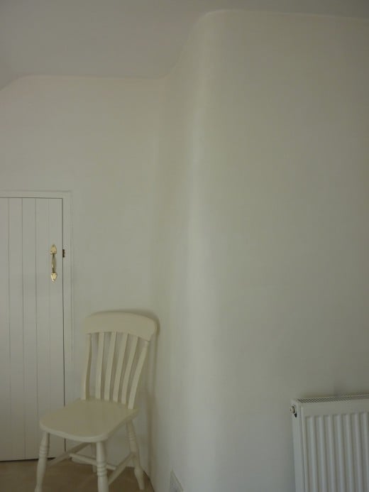 The curve of the chimney breast in a bedroom.