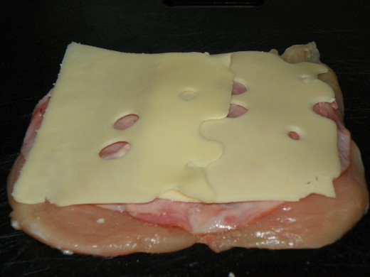 Chicken breast lightly seasoned, with salt & pepper and layered with ham and cheese.