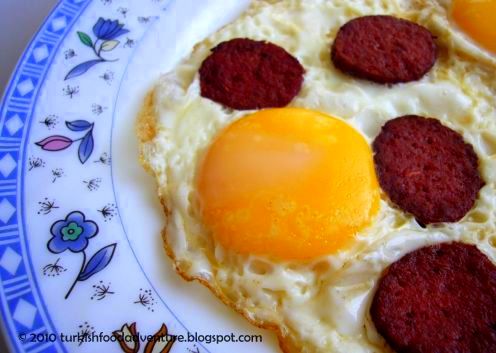Sucuklu Yumurta - Turkish Style Fried Eggs Topped with Dry Spicy Beef Sausage. 