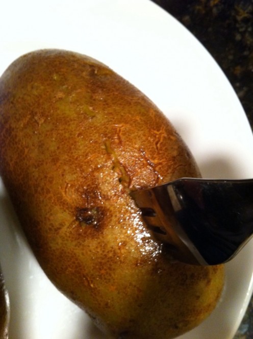 Holes poked in potato with fork