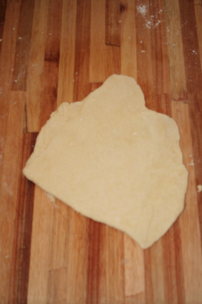 Pastry dough being rolled out, folded in half and rolled out again