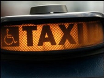 a lit up taxi for hire sign - a welcome sight for many women late at night