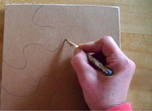 Use a pencil to mark the puzzle piece cuts.