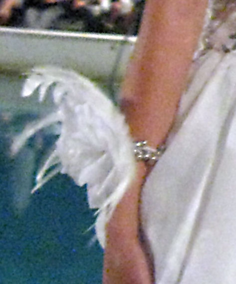 Feathers on a bracelet worn as part of a wedding ensemble.