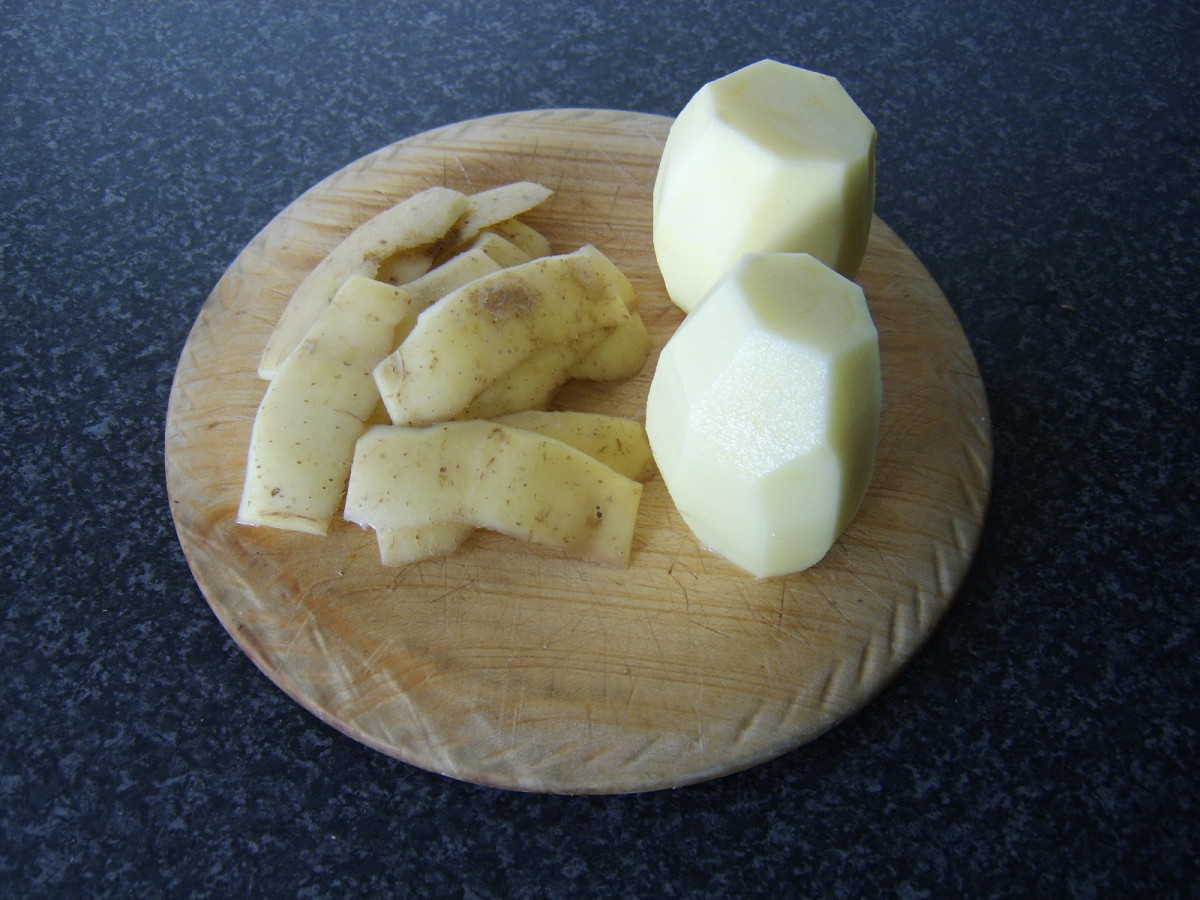 The skins are evenly sliced off the potatoes
