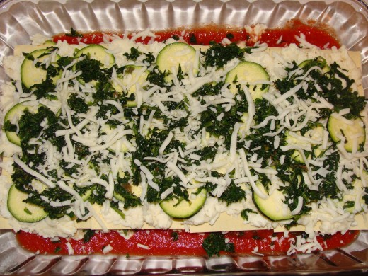 Sauce layered with noodles, cheese mixture, zucchini, spinach, and mozarella cheese.