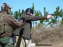 Firearms instructor working with student.
