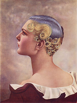 First Prize won at the Hairdressing Fashion Show London, 1935, using an Icall permanent-waving machine. The hair is shorter even than in the '20s and curls/waves are restricted to the back and sides, revealing the ears and neck. The colours were achi
