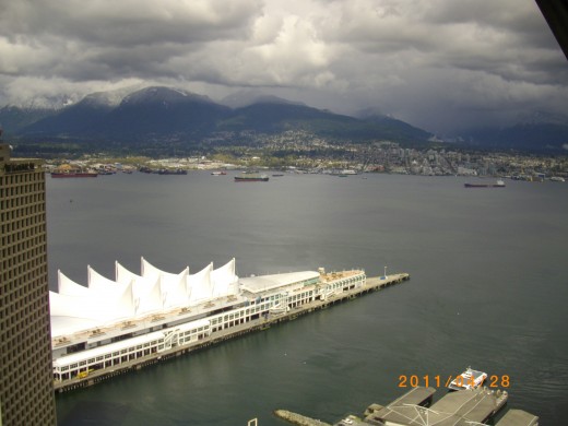 Canada Place is in the foreground and West Vancouver with the mountains is in the background.