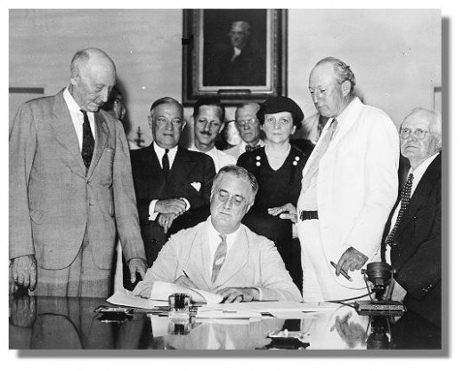 President Franklin D. Roosevelt, signing Social Security Act of 1935 in the Cabinet Room of theWhite House on August 14.. Library of Congress photo.