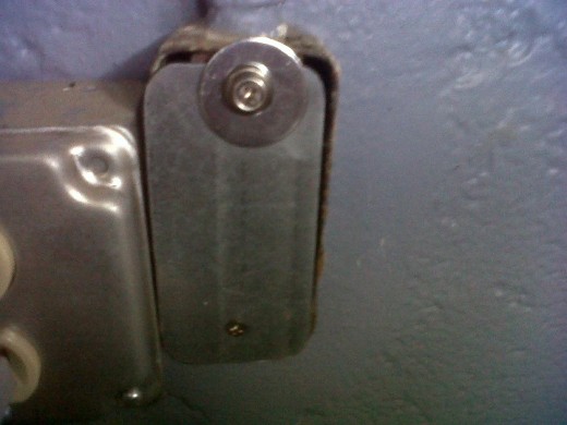Instead of buying a $2 plate to cover up this open electrical receptacle, we rigged up a piece of scrap metal to somewhat cover it up.