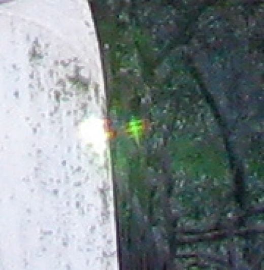Close up of second photograph, taken seconds after the first.  This time only one Elemental appears.  The tiny light is lower and closer to the monument and you can see it's glow on the opposite side of the monument as the sun.  