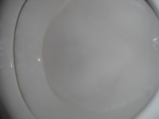 Baking soda and vinegar reaction in toilet bowl.