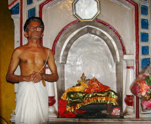 The priest with the idol of Gopal inside Gopal temple, Khandra
