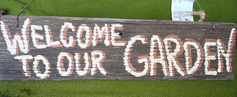 Hang a handpainted  barnwood sign by Scrappy Signs in your garden. 