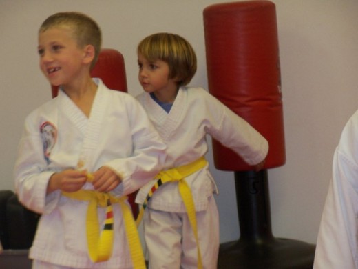 Belt systems offering stripes, as seen on these yellow belts, for the lower belts keep younger children motivated to master formation.