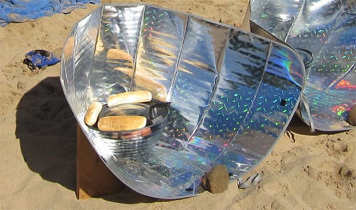 A reflector solar cooker, one of several kinds of solar ovens.