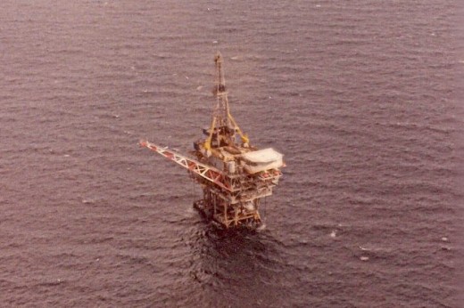 Rig off the Texas coast with Jack-up drilling rig hooked up. Notice the derrick?