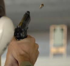Beretta pistol ejecting empty brass during firing cycle