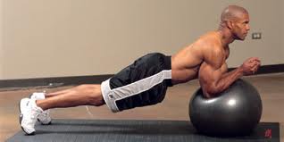Elbow planks on stability ball. Roll elbows back and forth or extend arms from this position for a harder exercise.