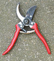 This tool has a spring action handles and small sharp blades. Can be used with either hand.
