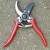 This tool has a spring action handles and small sharp blades. Can be used with either hand.