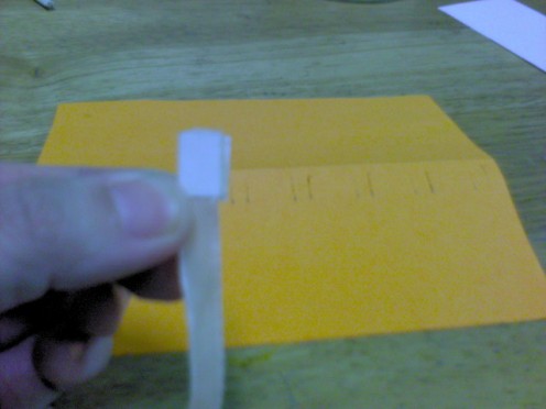 Paste a little double-sided tape on one end of the ribbon.