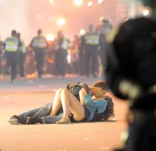 These two had just exited the Roger's Arena when mistaken by the police for rioters. She was knocked to the ground and he proceeded to comfort her from the shock of police attack. They were not rioters. He is a tourist! The story has gone viral.
