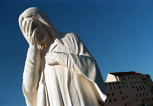 Marble statue of Jesus weeping.