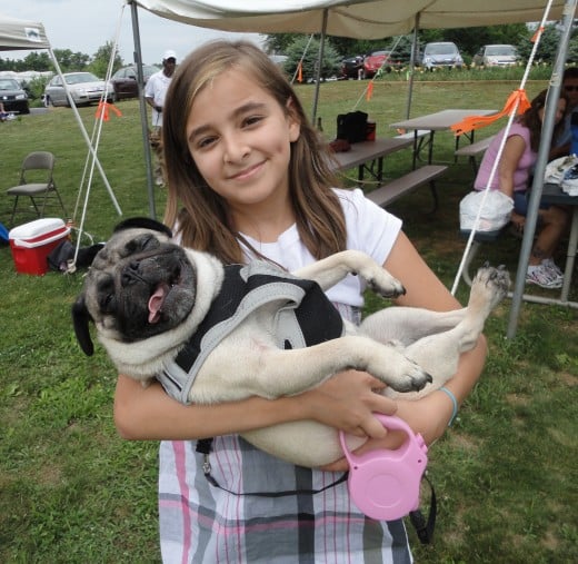 Image of 10-year-old Macie Montiel of Abbottstown, Pa., holding her Pug, Odie.
