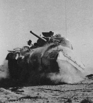 M4 Sherman Tank Fighting in North Africa. This American made tank armed with a 75mm cannon gave the allies parity against the German Panzers of the Afrika Korps. 