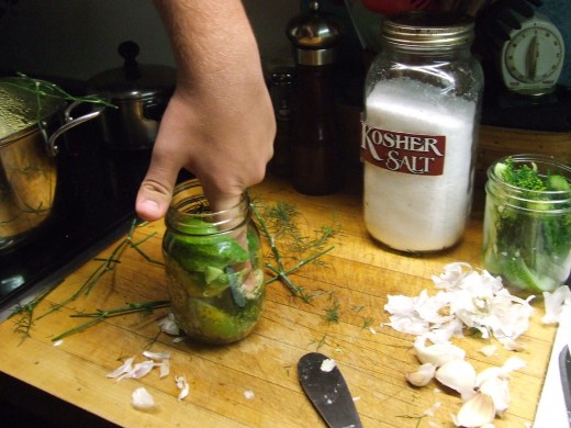 Put the Garlic and Fresh Dill in First. Then Pack the Cucumbers in as many and as tight as you can, without crushing the cucumbers..