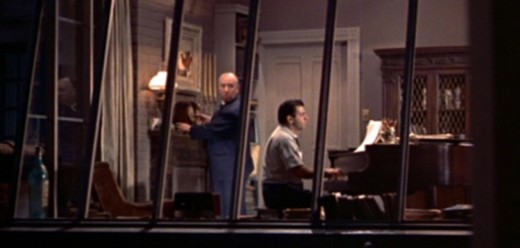 Hitchcock made one of his famed cameo appeances standing in the apartment of a composer across the way.