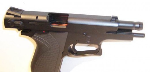 Examples of handguns with their actions open and empty. Note that you can see the orange magazine follower in the semi-auto. This indicates that the magazine is empty.