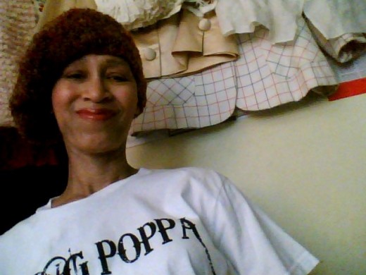 Victoria Moore in a "Yung Poppa" t-shirt and a brown tam made by Naomi Y. of Los Angeles, CA. for "The Giving Caps Group".