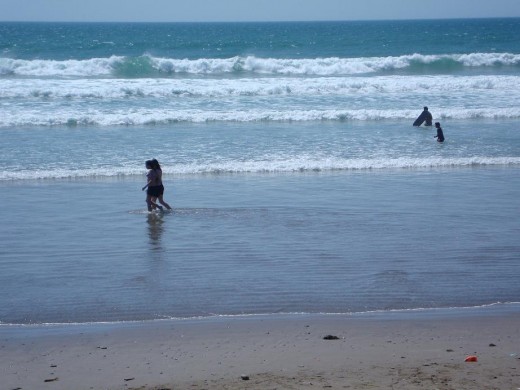 Realxing: Two young girls walk through the sea