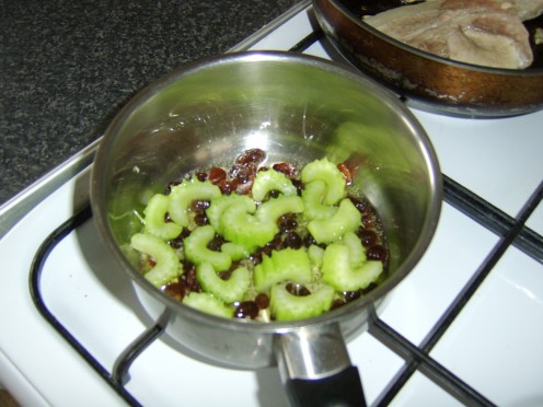 The celery. raisins and garlic are briefly heated in the oil