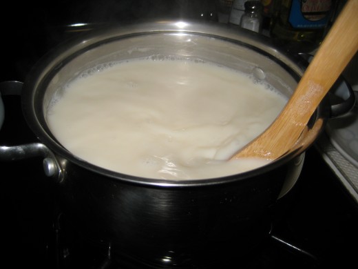 Soymilk is boiling.  Remove foams with spoon.  Add sugar to suit your taste.  