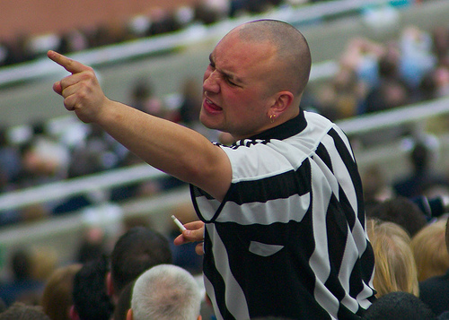 This fan is demonstrating move no. 54 in the supporters guide 'the aggressive point'. One of the many moves you need to be familiar with at a football match. 