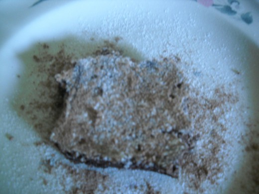 Basic chocolate brownie dusted with powdered sugar and cocoa powder