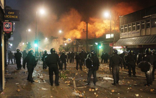 Riot Police look on as Parts of London burns to the ground