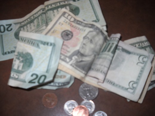 Money, US dollar bills and loose change