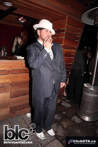 A sure-sign of a real loser is a guy who 'thinks' that he is among the well-dressed. Well, you can tell by this outdated suit and hat, that the only place he fits in would be on Jersey Shore.
