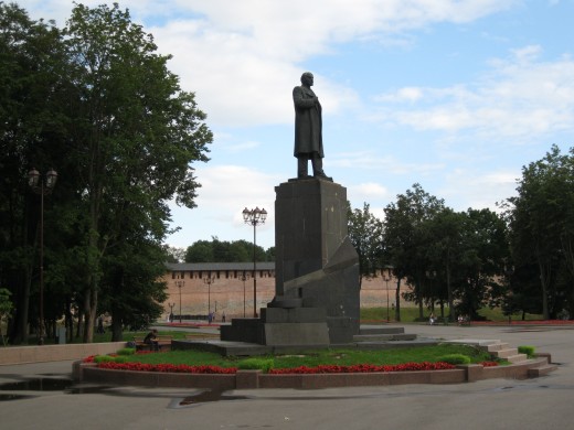 Statue of Vladimir Lenin with wall of Veliky Novgorod Kremlin in background.  