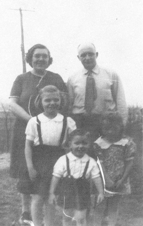 My grand-parents with their children in a family portrait.