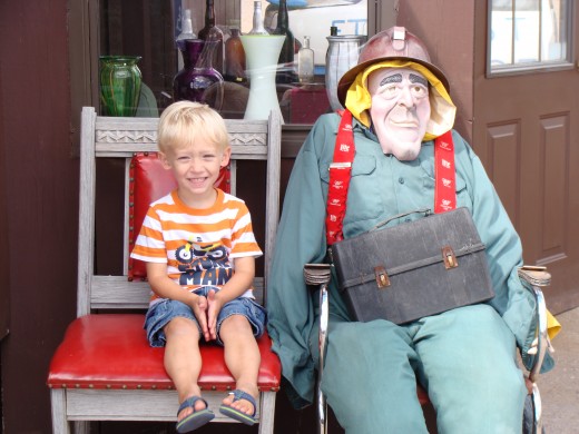 Alex sitting next to a miner.
