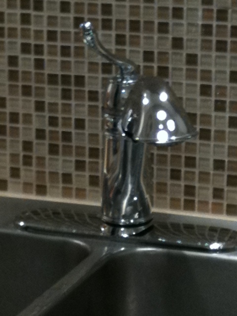 An attractive glass tile and upgraded faucet can make an inexpensive decorating idea. Install both yourself and save.
