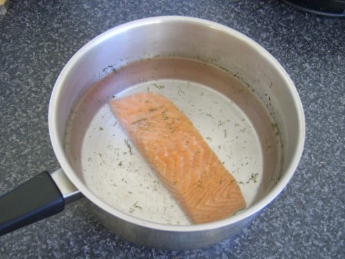 Enough cold water is added to comfortably cover the salmon fillet