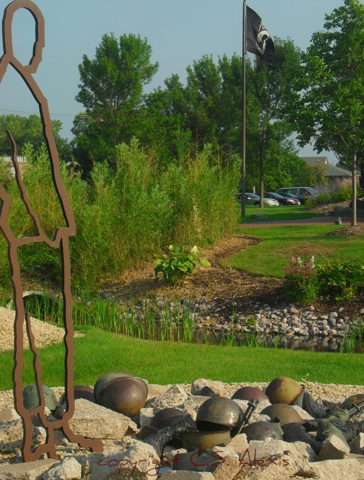 Helmets made to protect the men and women who fought to protect our freedom now rest silently as part of this sculpture that opens the story at Munster Indiana's veterans memorial park.
