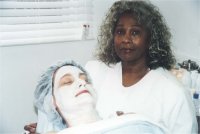 Thelma performing a facial which is one of her specialties